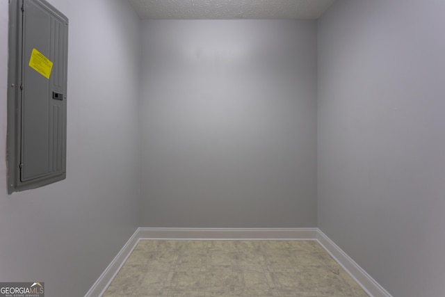 unfurnished room with a textured ceiling and electric panel