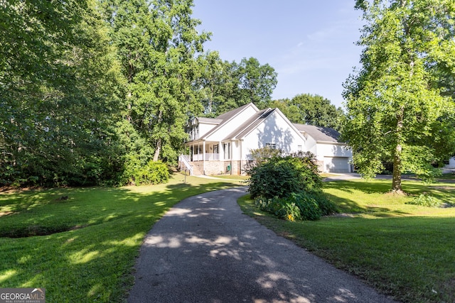 view of front of property featuring covered porch and a front yard