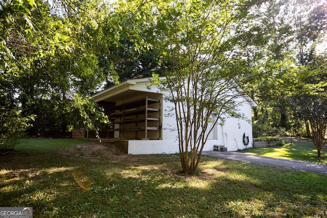 view of side of home featuring a yard