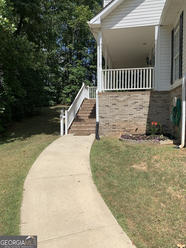 view of side of home with a lawn