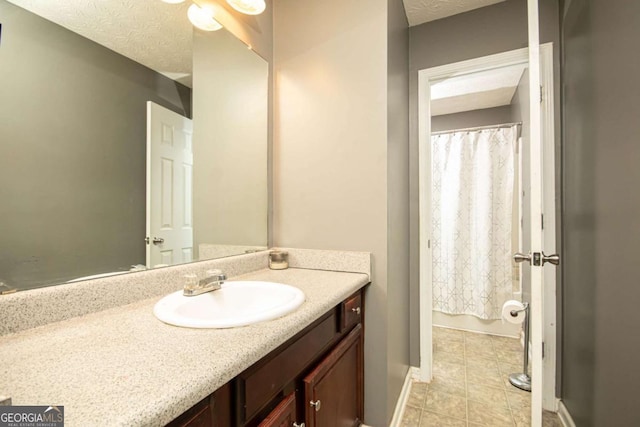 bathroom featuring vanity and a textured ceiling