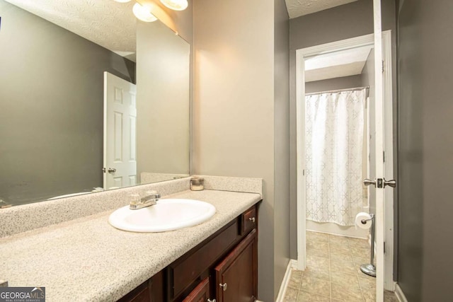 bathroom with a textured ceiling and vanity