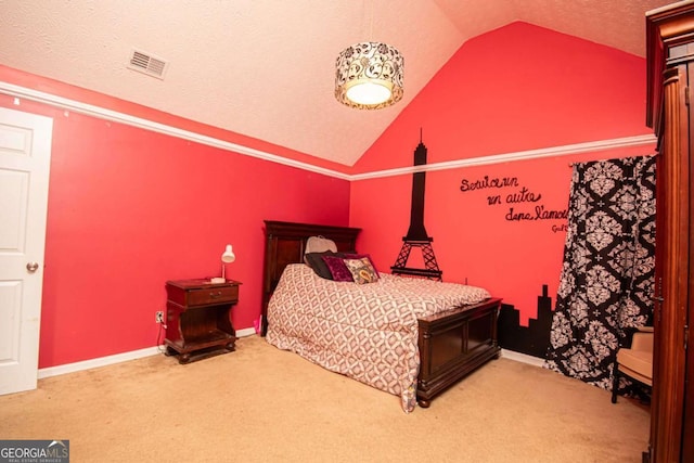 bedroom with vaulted ceiling, carpet, and a textured ceiling