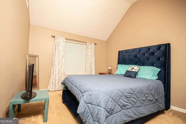 carpeted bedroom featuring lofted ceiling