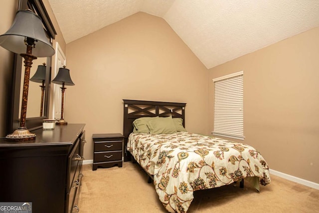 carpeted bedroom with a textured ceiling and lofted ceiling