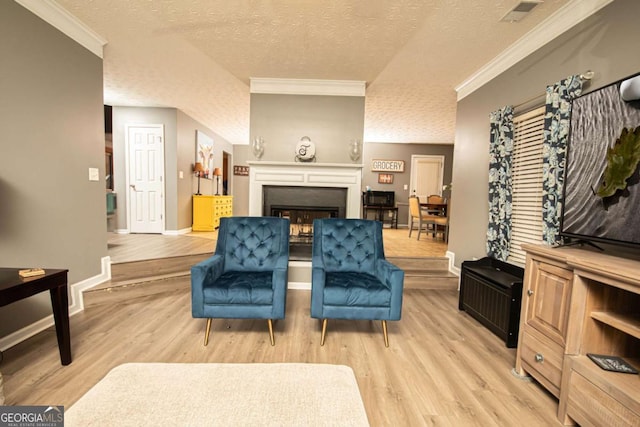 interior space with crown molding, a textured ceiling, and light hardwood / wood-style floors