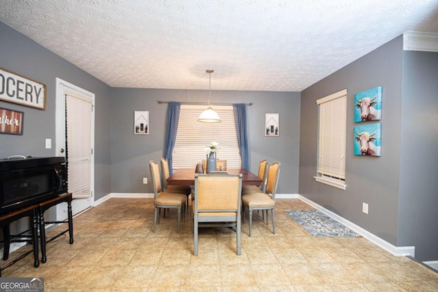 dining space featuring a textured ceiling