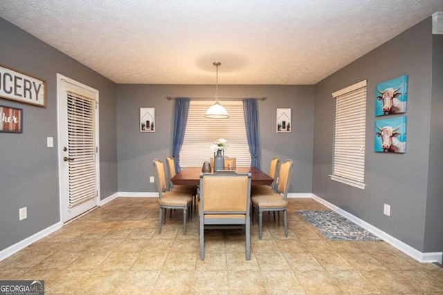 dining space featuring a textured ceiling