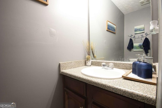 bathroom featuring vanity and a textured ceiling