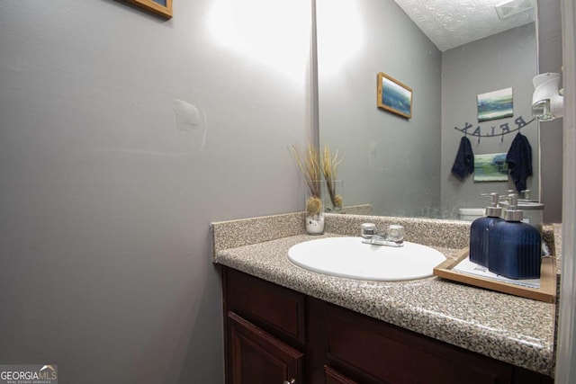 bathroom featuring vanity and a textured ceiling