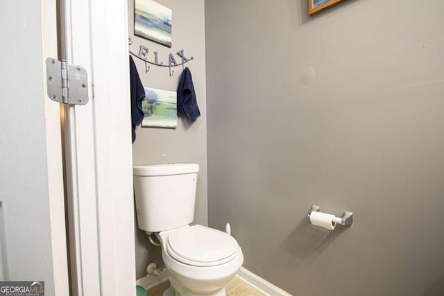 bathroom featuring toilet and tile patterned flooring