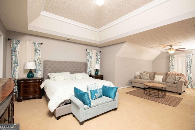 carpeted bedroom with ceiling fan, a textured ceiling, a raised ceiling, and ornamental molding