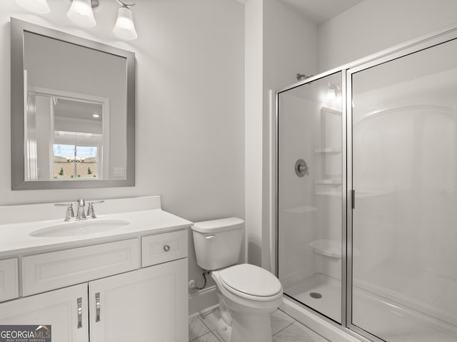 bathroom with toilet, walk in shower, and vanity