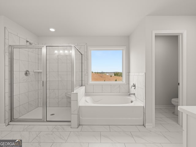 bathroom featuring toilet and plus walk in shower