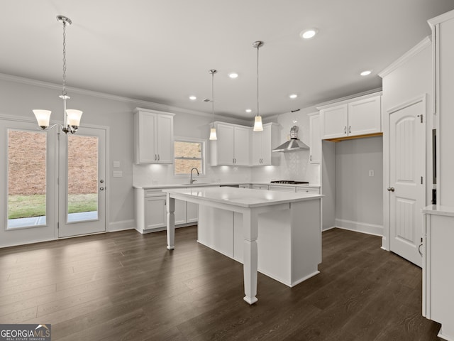 kitchen featuring pendant lighting, white cabinets, and a center island