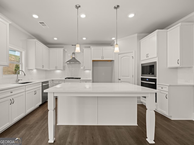 kitchen with black appliances, a kitchen island, white cabinetry, sink, and hanging light fixtures