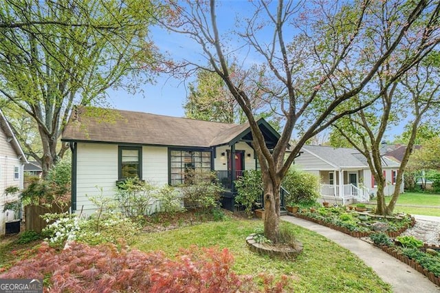 ranch-style home with a porch and a front lawn