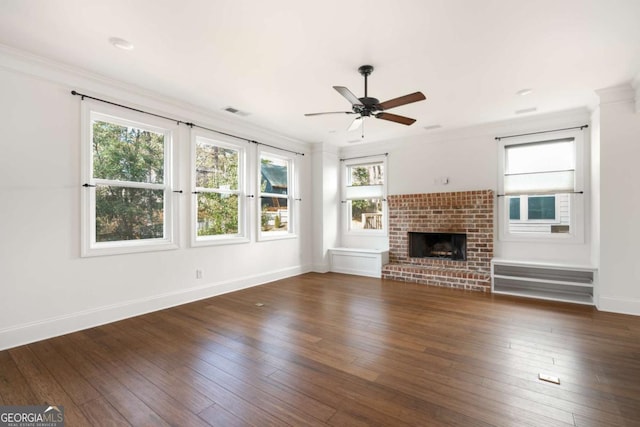 unfurnished living room featuring ceiling fan, a brick fireplace, and crown molding