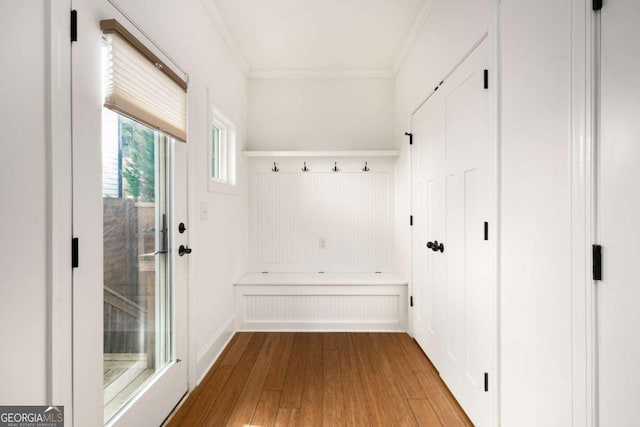 mudroom with light wood-type flooring and ornamental molding