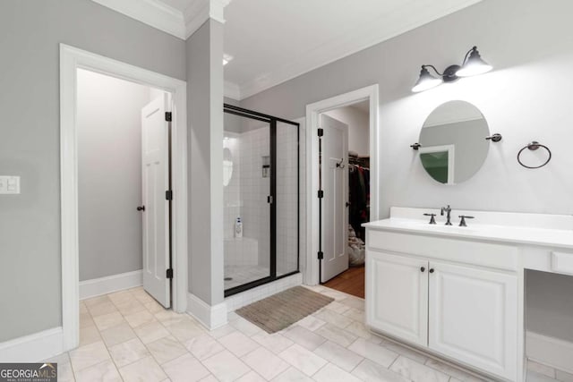 bathroom with vanity, ornamental molding, tile patterned floors, and a shower with door