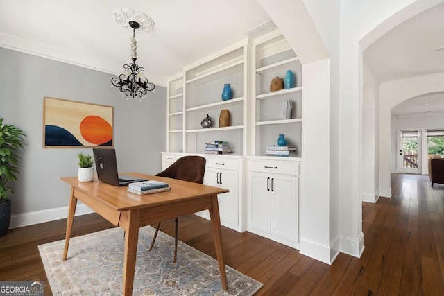 office space featuring built in shelves, dark hardwood / wood-style flooring, and a notable chandelier