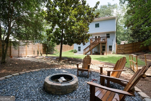 view of patio featuring an outdoor fire pit and a wooden deck