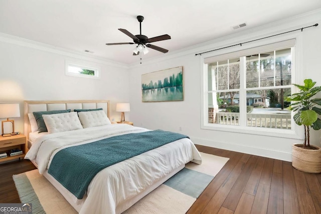 bedroom featuring ceiling fan, dark hardwood / wood-style flooring, and ornamental molding