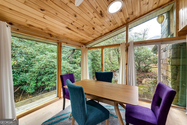 sunroom / solarium with a healthy amount of sunlight, vaulted ceiling, and wooden ceiling