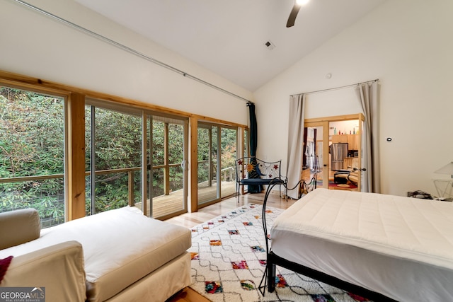 bedroom with ceiling fan, wood-type flooring, and high vaulted ceiling