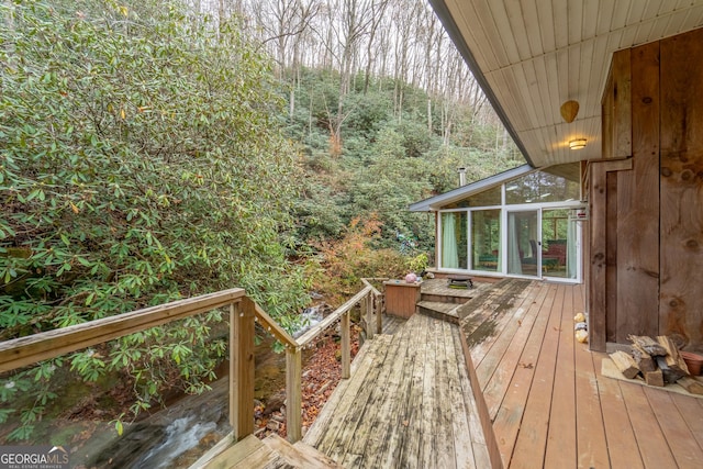 wooden terrace featuring a sunroom