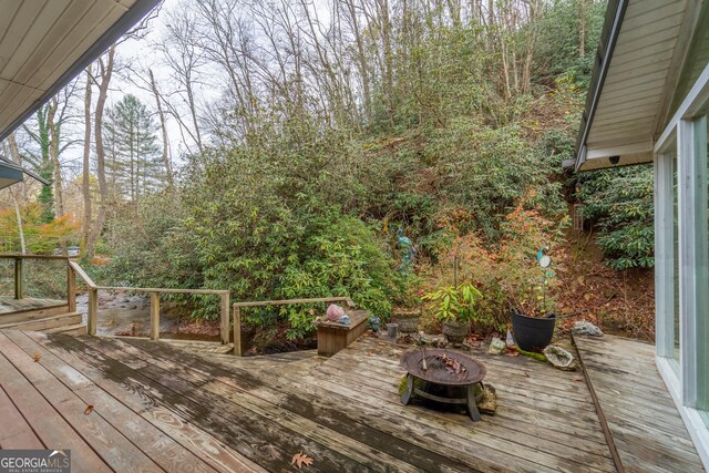 wooden terrace with a fire pit