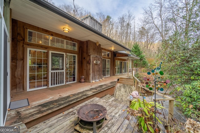 wooden deck featuring a fire pit