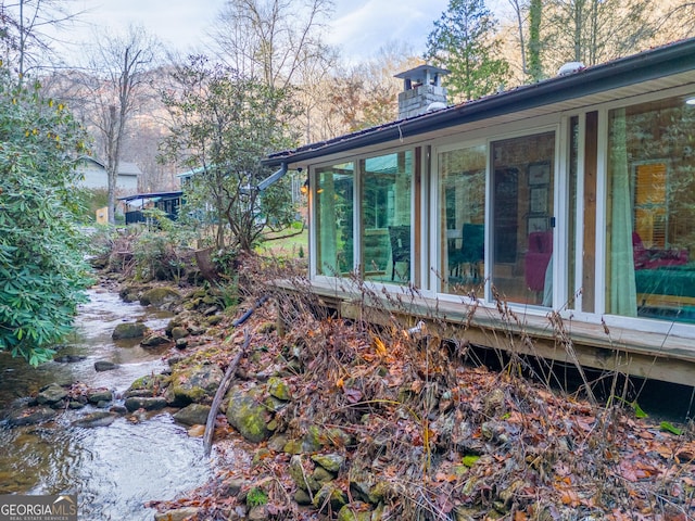 view of side of home with a sunroom