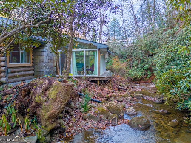 view of property exterior featuring a sunroom