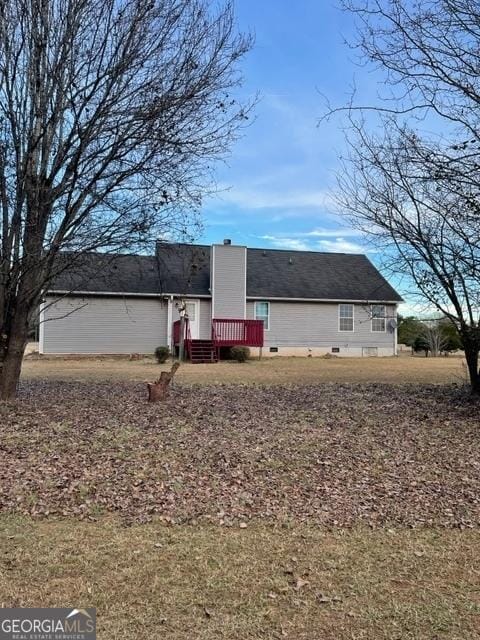 rear view of property with a yard