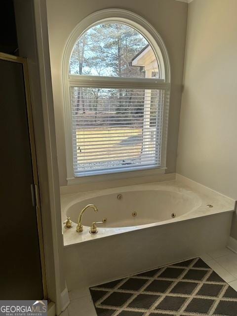 bathroom featuring tile patterned flooring and a tub