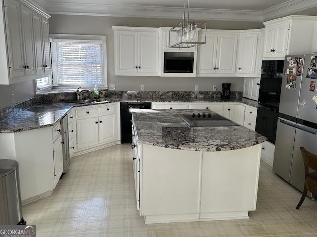 kitchen featuring white cabinetry, a center island, hanging light fixtures, black appliances, and sink