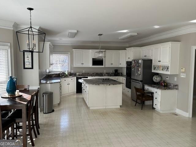 kitchen featuring pendant lighting, white cabinets, and a center island