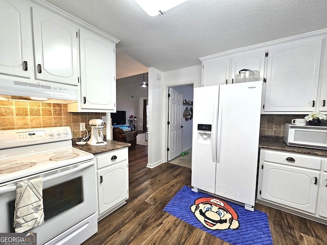 kitchen with white appliances, white cabinetry, decorative backsplash, and dark wood-type flooring