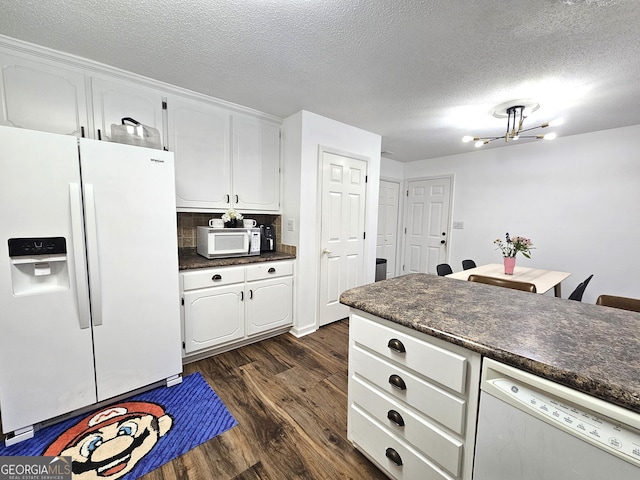 kitchen featuring white appliances, a textured ceiling, dark wood-type flooring, white cabinetry, and tasteful backsplash