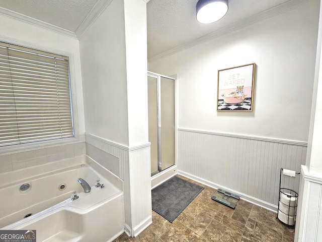 bathroom with a textured ceiling, crown molding, and plus walk in shower