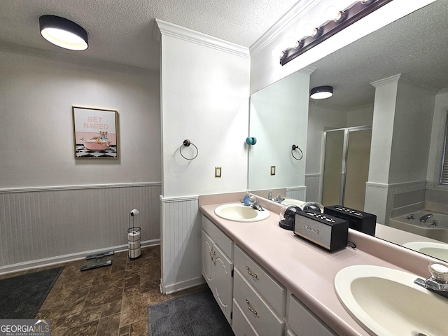 bathroom with a textured ceiling, vanity, shower with separate bathtub, and ornamental molding