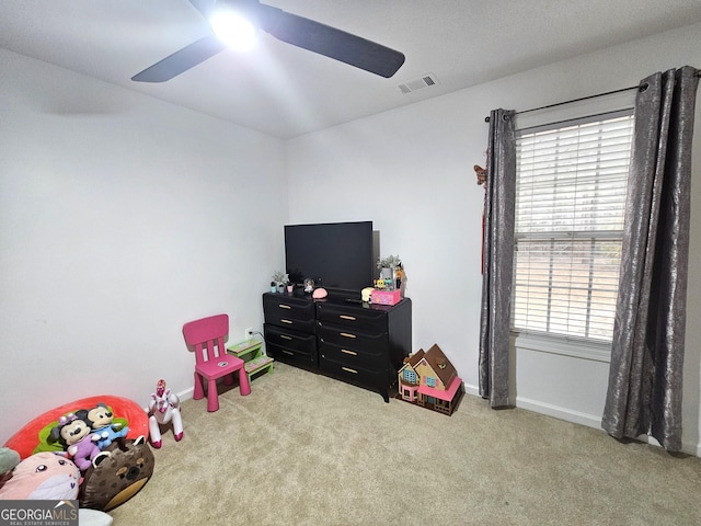 rec room featuring light carpet and ceiling fan