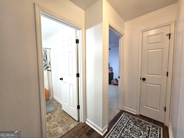 hallway with a textured ceiling