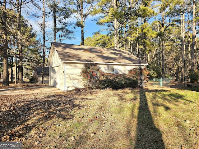 view of side of property with a yard and a garage