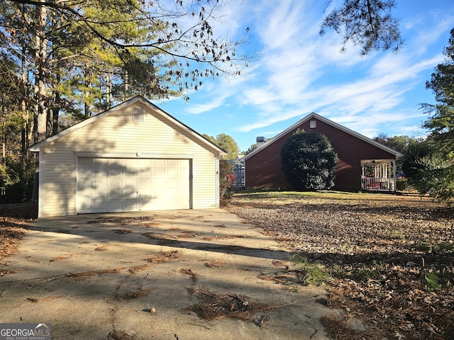 view of property exterior with an outdoor structure and a garage