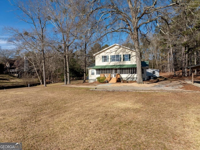 view of front of property with covered porch and a front yard