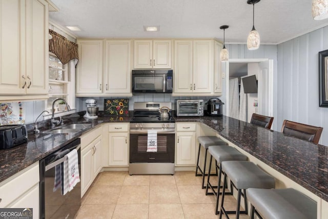 kitchen with light tile patterned flooring, a kitchen breakfast bar, stainless steel range with electric cooktop, and pendant lighting