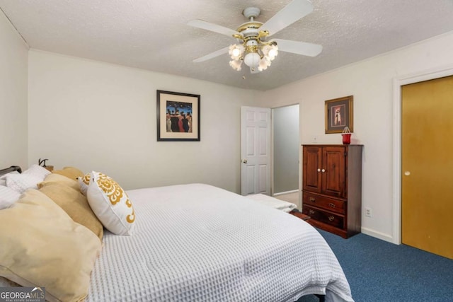 carpeted bedroom featuring a textured ceiling and ceiling fan