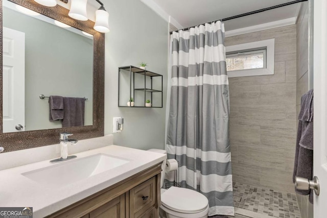 bathroom with toilet, vanity, and a shower with curtain